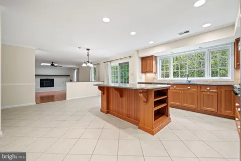 a kitchen with granite countertop a stove and a sink