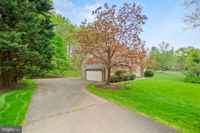 a pathway of a house with a yard