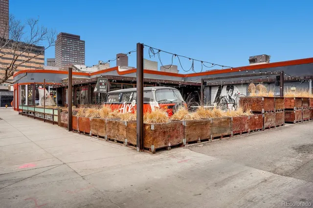 a front view of a house with large windows and city view