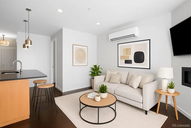 a living room with furniture a flat screen tv and a window
