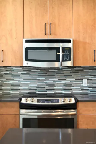 a stove top oven sitting inside of a kitchen