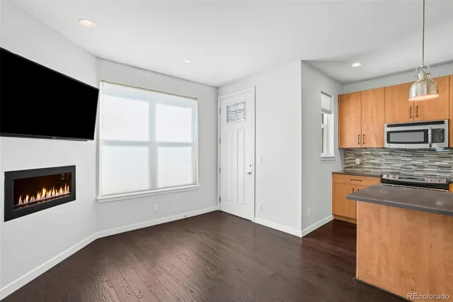 a view of kitchen with microwave a stove and a window