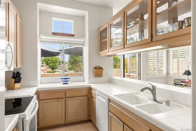 a kitchen with a sink stove and cabinets