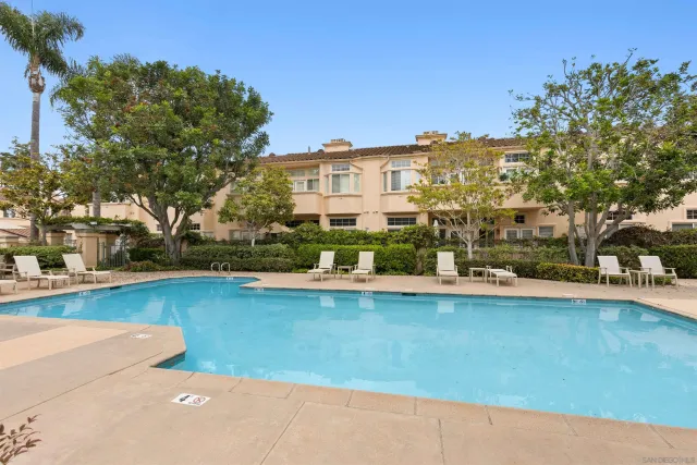 a front view of multiple houses with yard
