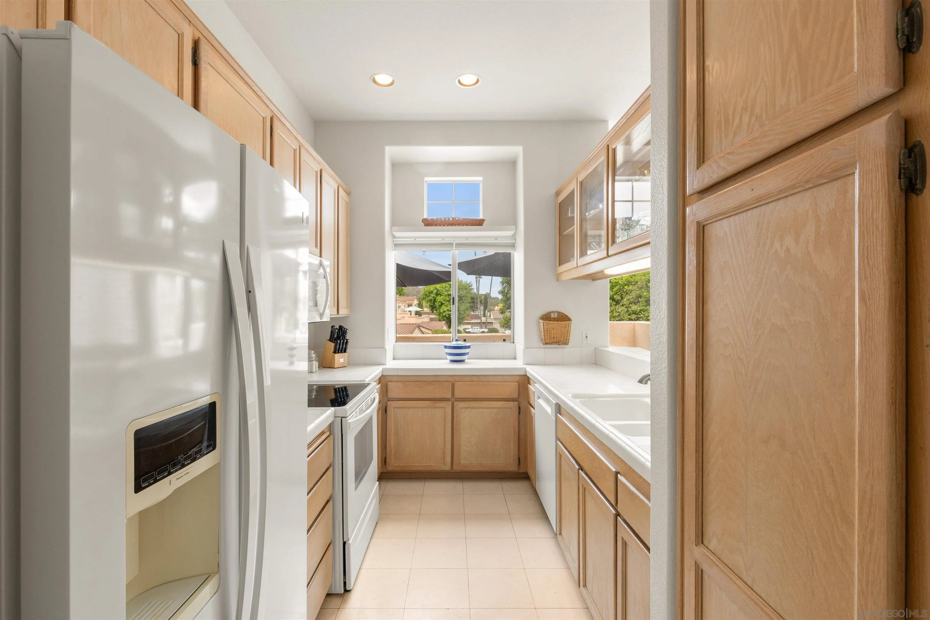 5609 Avenida De Parque Rancho Santa Fe, CA 92091 - Photo 10 of 26 a kitchen with white cabinets and white appliances