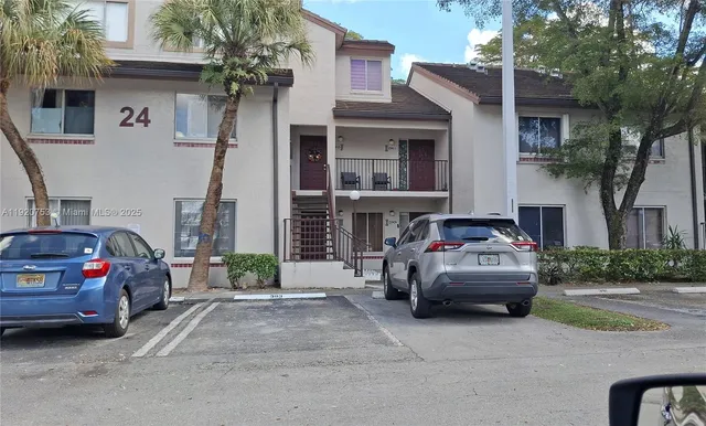 a view of a car parked in front of a house