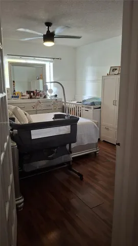 a view of hall way with furniture and wooden floor