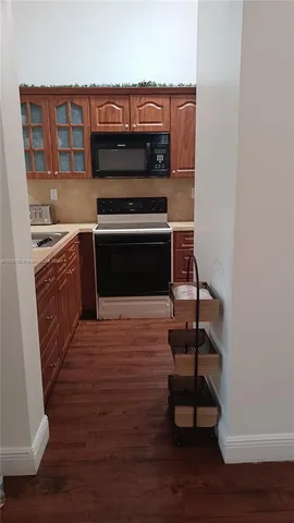a room with wooden floor and a fireplace