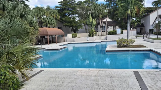 a view of a house with patio and a garden