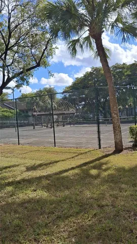 a view of a yard with basketball court