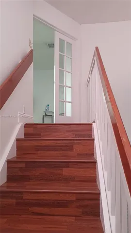 a view of entryway and hall with wooden floor
