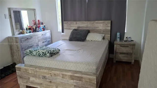 a bedroom with a bed and a dresser