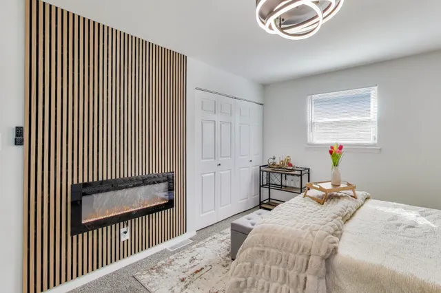 a bedroom with a bed and a chandelier