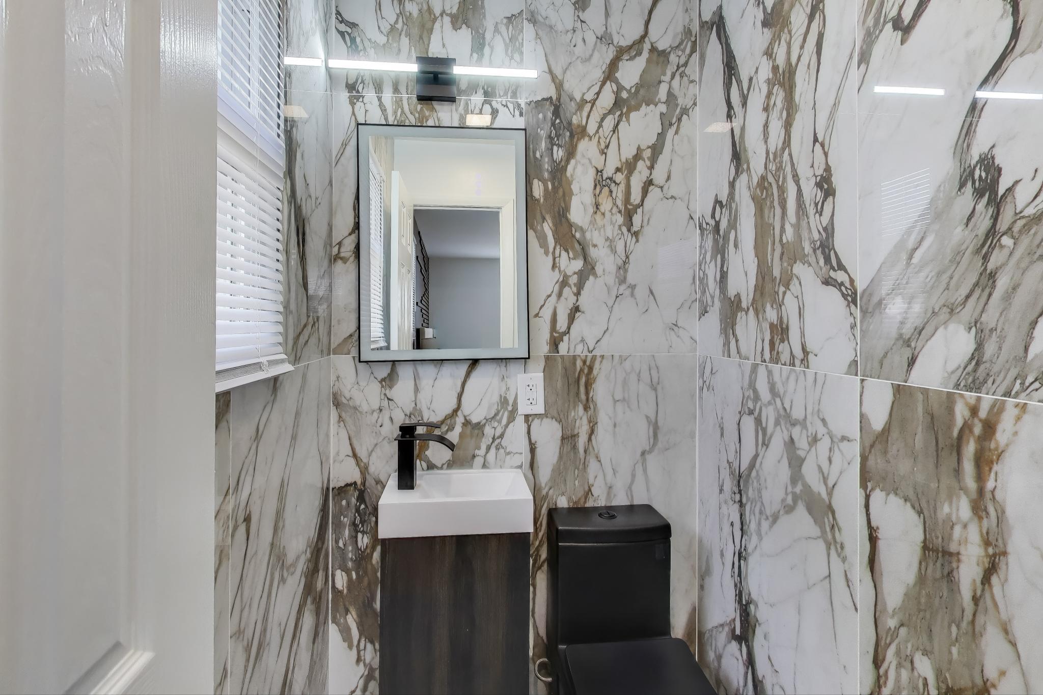 1124 Clinton Street Gary, IN 46406 - Photo 25 of 52 a bathroom with a sink and a mirror