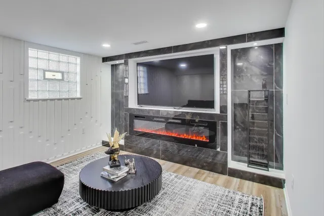 a living room with furniture and a wooden floor