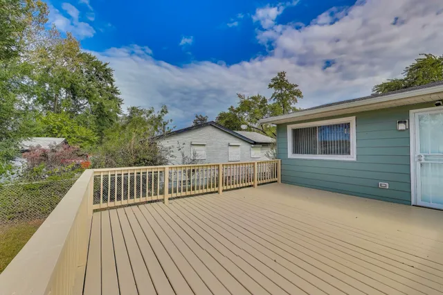 a front view of a house with a garden and yard
