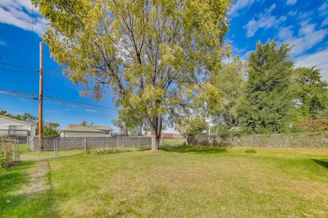 a view of yard with swimming pool and green space