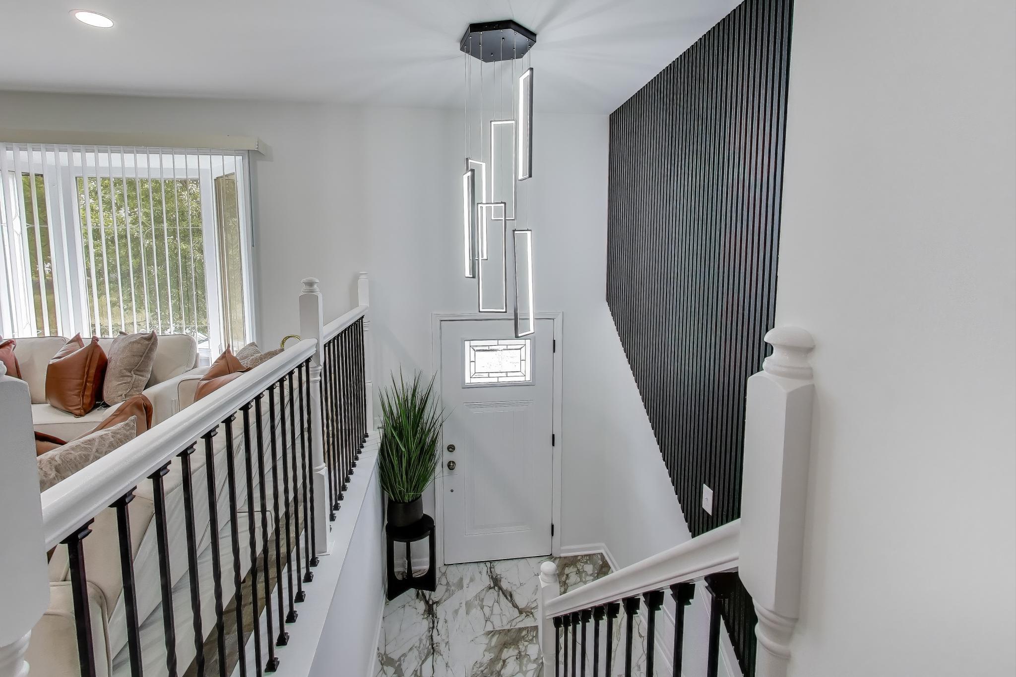 1124 Clinton Street Gary, IN 46406 - Photo 5 of 52 a view of staircase with lots of frames and flower pot
