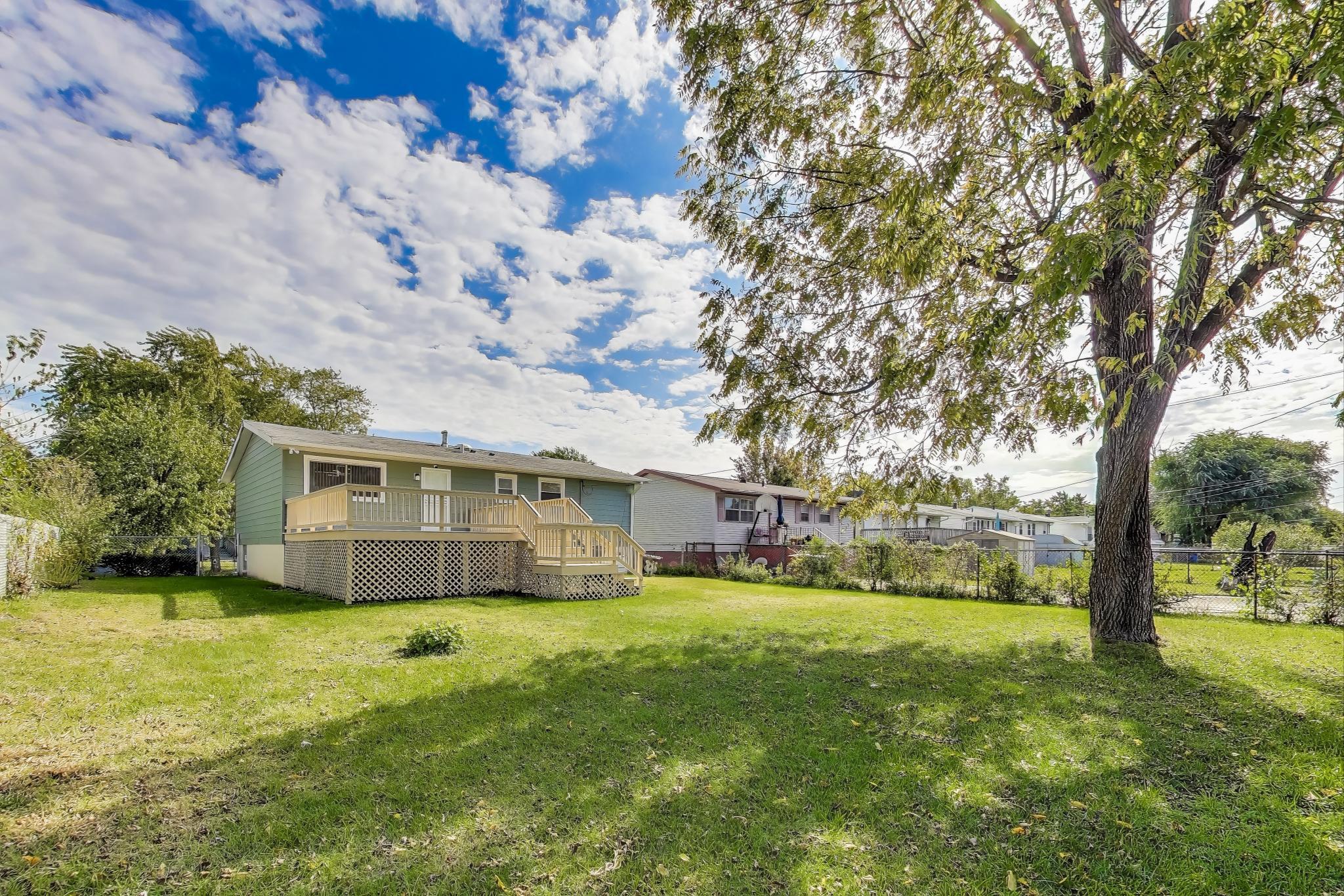 1124 Clinton Street Gary, IN 46406 - Photo 52 of 52 a view of a house with a big yard and large tree