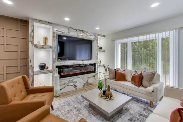 a living room with fireplace furniture and a flat screen tv