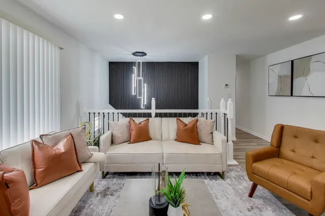a living room with furniture and a potted plant