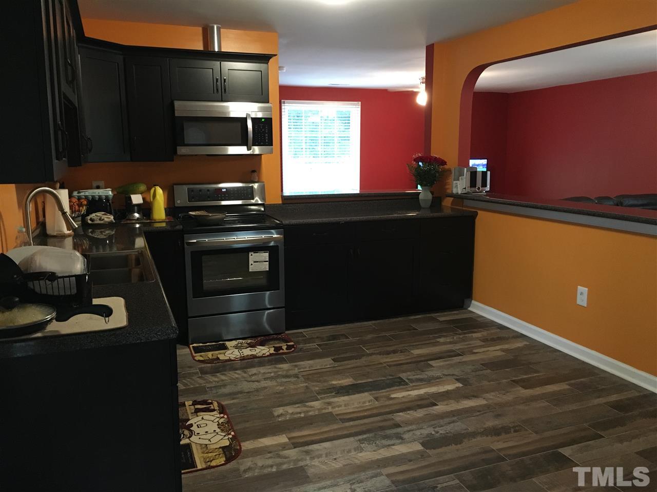 795 Old Durham Road Roxboro, NC 27573 - Photo 1 of 9 a kitchen with a sink appliances and cabinets