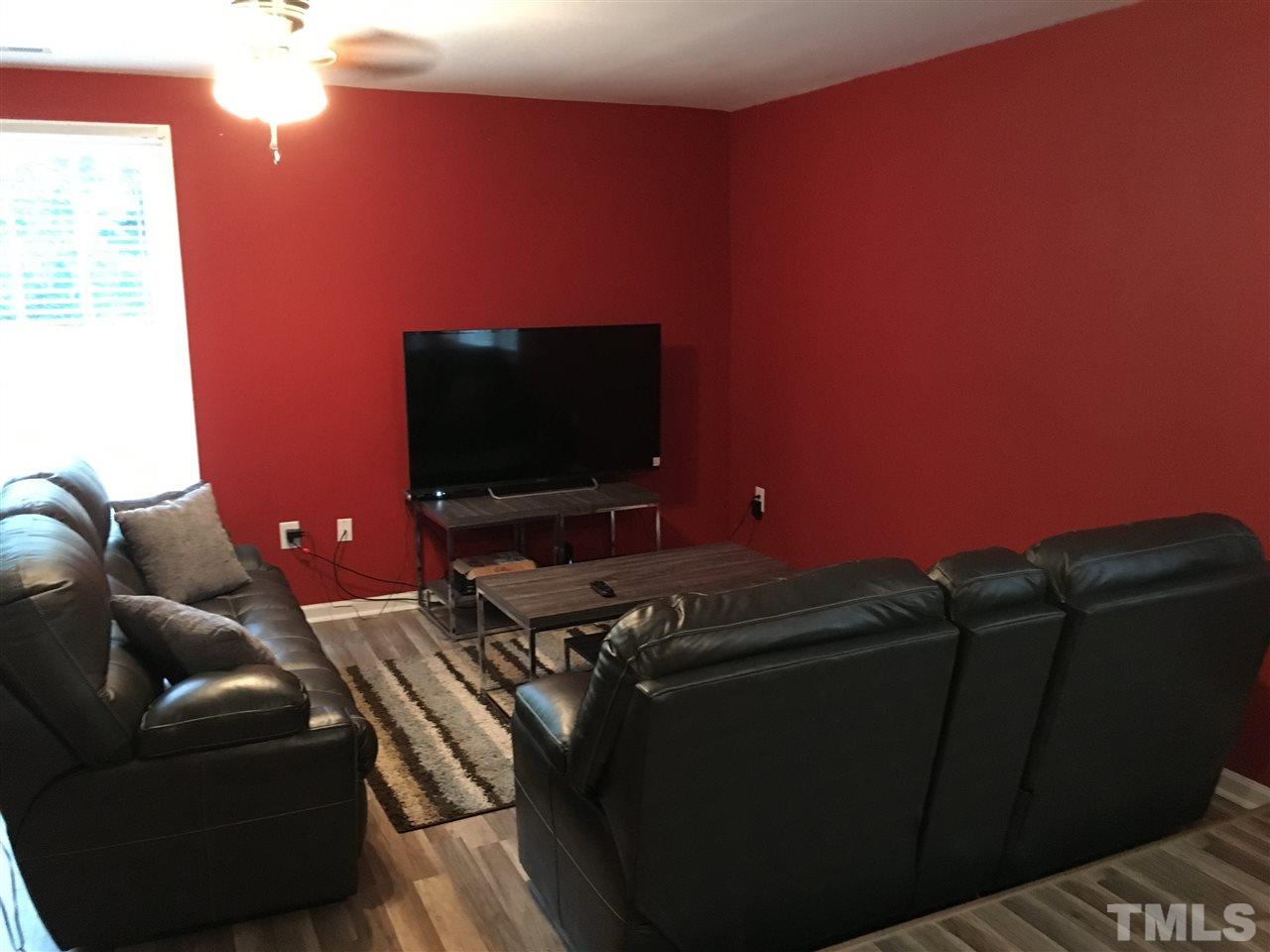 795 Old Durham Road Roxboro, NC 27573 - Photo 3 of 9 a living room with furniture and a flat screen tv
