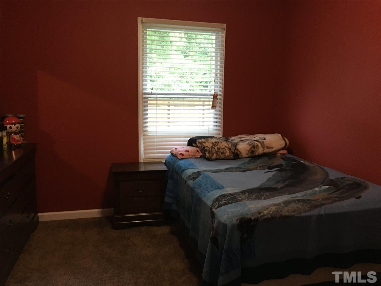 795 Old Durham Road Roxboro, NC 27573 - Photo 8 of 9 a bed sitting in a bedroom next to a window