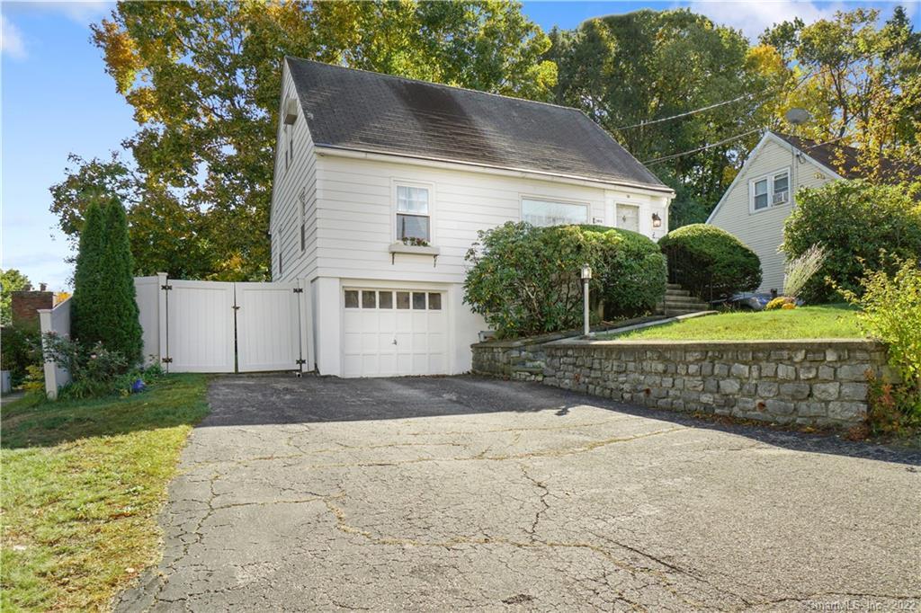 35 Deerfield Avenue Waterbury, CT 06708 - Photo 1 of 1 a front view of a house with a yard and garage
