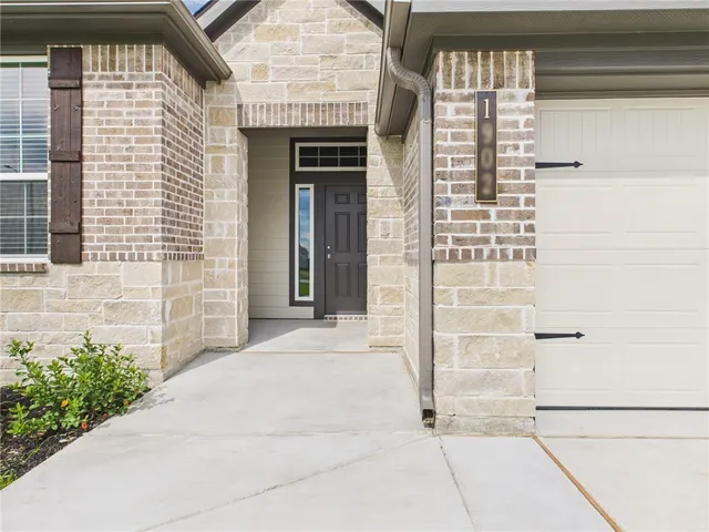 a view of a brick house with front door