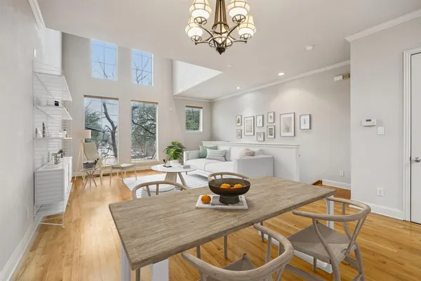 a living room with dining table and wooden floor