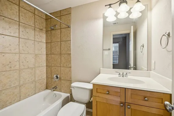 a bathroom with a sink vanity mirror and toilet