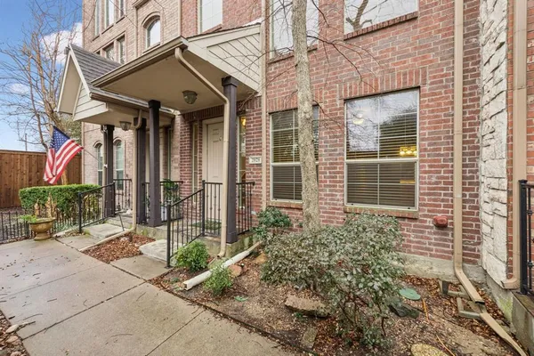 a view of a brick house with potted plants