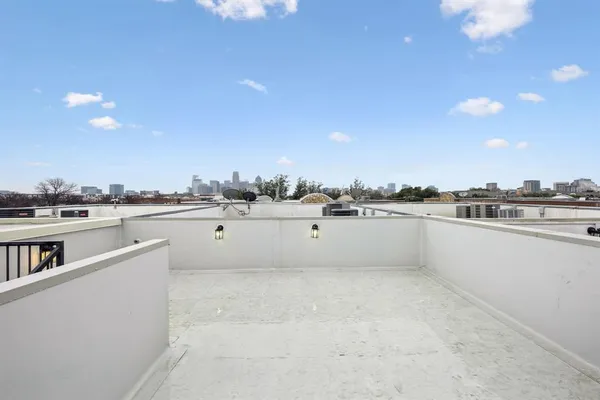 a view of a kitchen with kitchen island and a sink