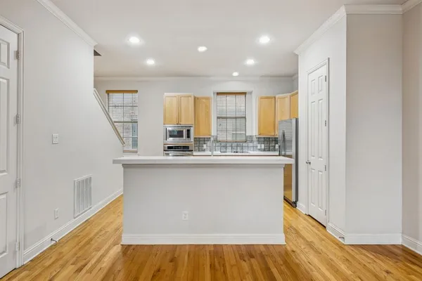 a kitchen with stainless steel appliances granite countertop a refrigerator and a sink