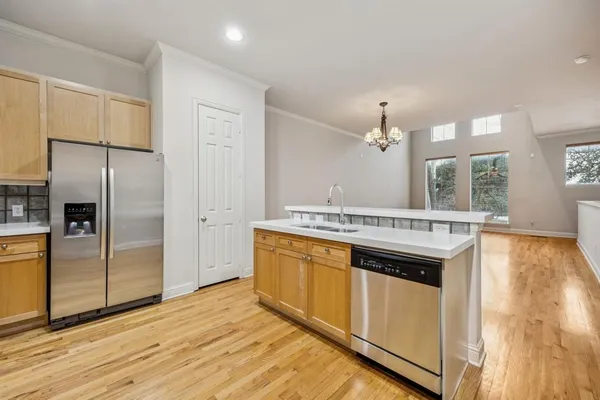a kitchen with stainless steel appliances granite countertop a refrigerator a stove and a sink