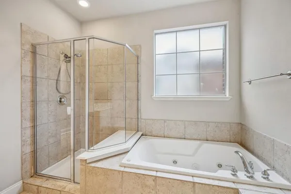 a bathroom with a bath tub and shower