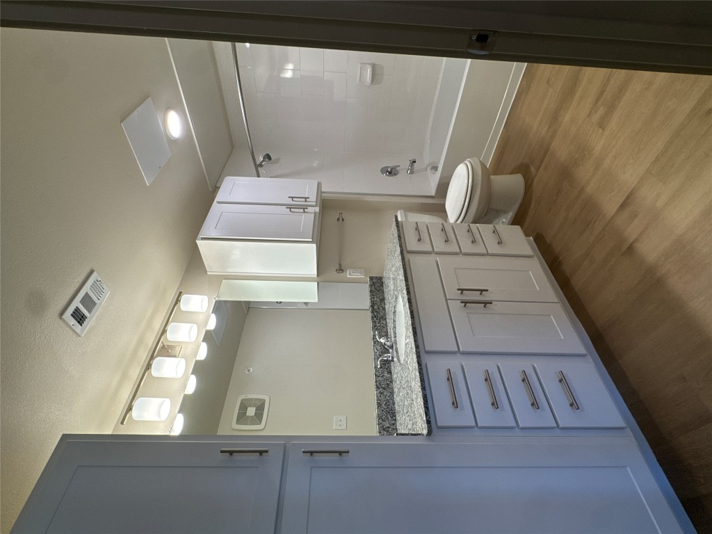 691 Union Chapel Road, Unit A2 Cedar Creek, TX 78612 - Photo 12 of 21 Bathroom with vanity, shower / bathtub combination, and wood style floors