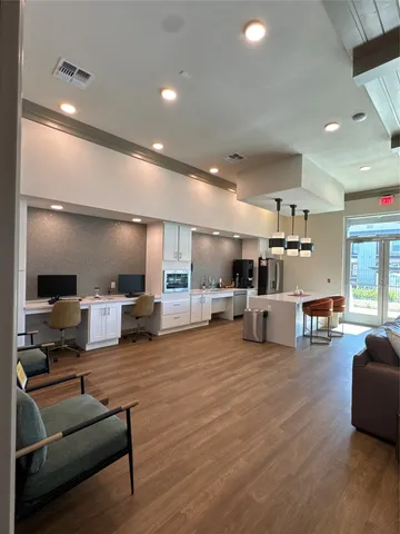 a living room with furniture and kitchen view