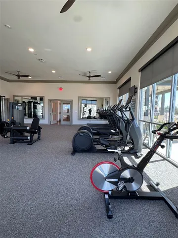 a room with gym equipment and a large window