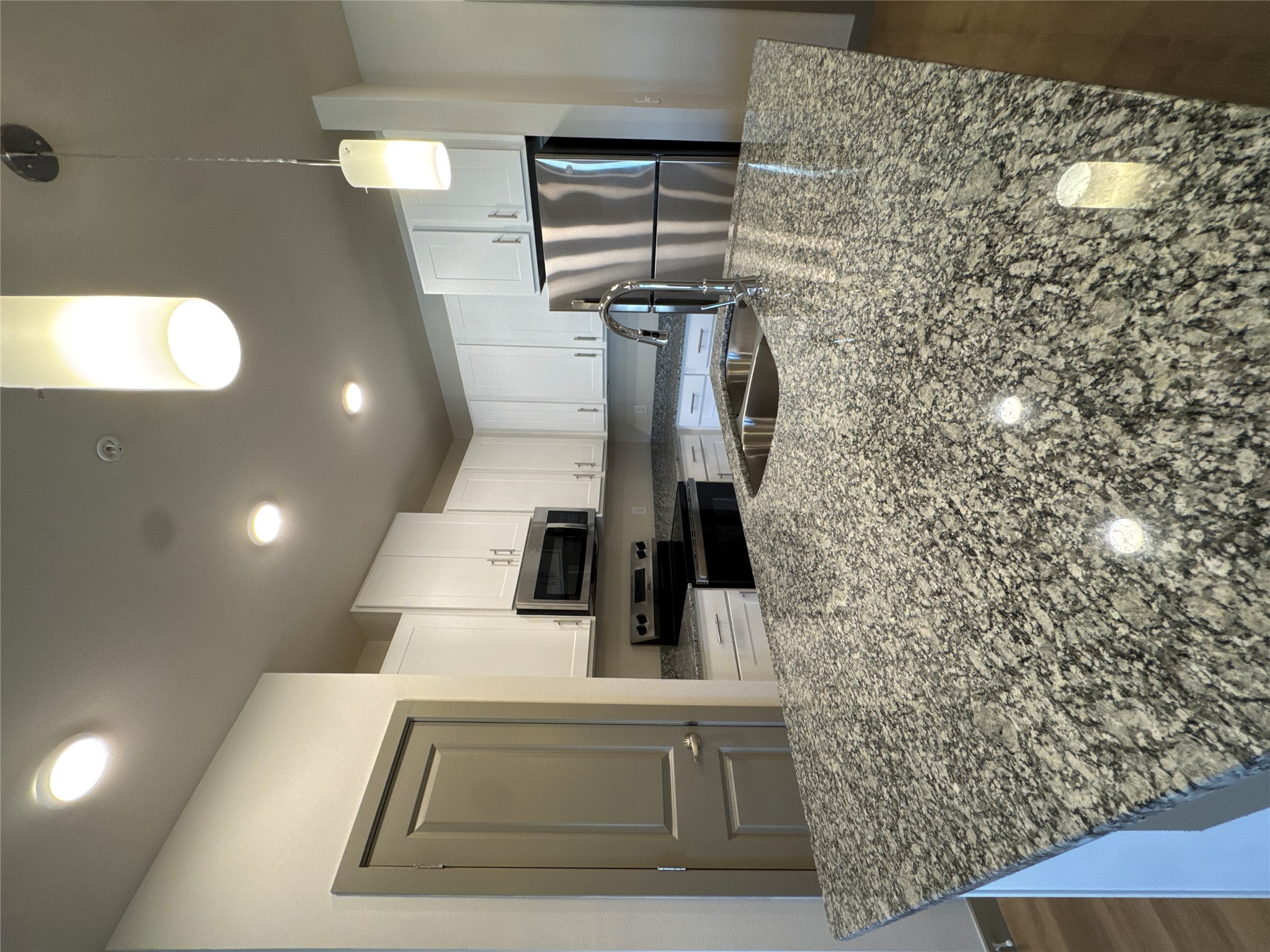 691 Union Chapel Road, Unit A2 Cedar Creek, TX 78612 - Photo 7 of 21 a kitchen with kitchen island granite countertop a refrigerator oven a sink and dishwasher