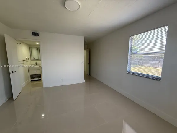 a view of a kitchen with a sink and a refrigerator