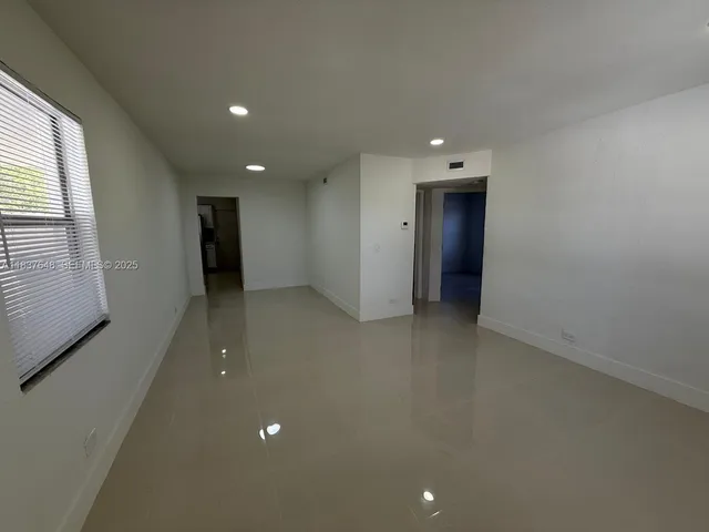 an empty room with closet and a window