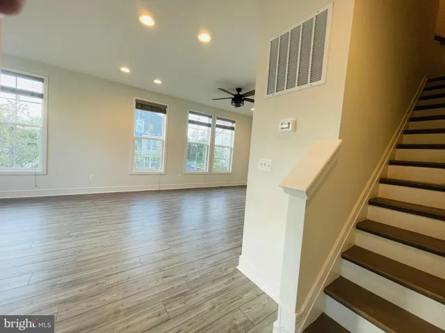 a view of an entryway with wooden floor and staircase