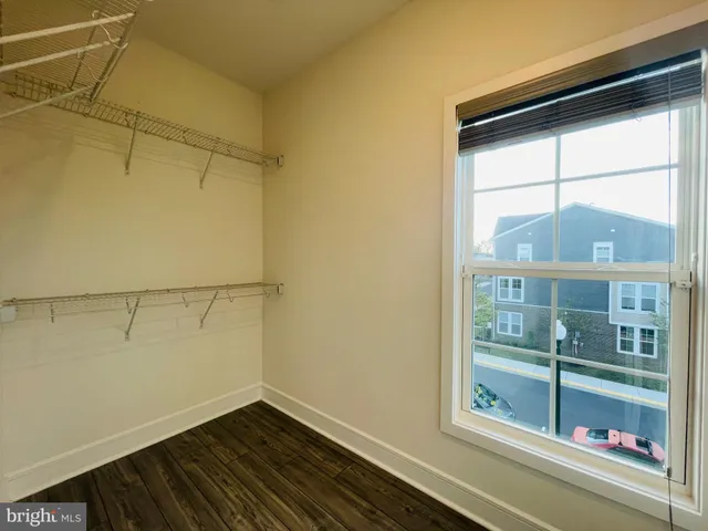 a view of a room with wooden floor and windows