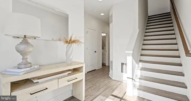 a view of entryway and hall with wooden floor