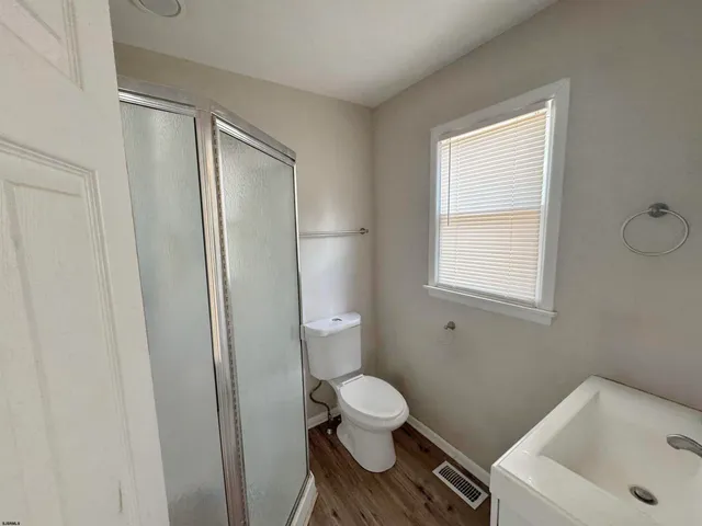 a white toilet sitting next to a bathroom sink