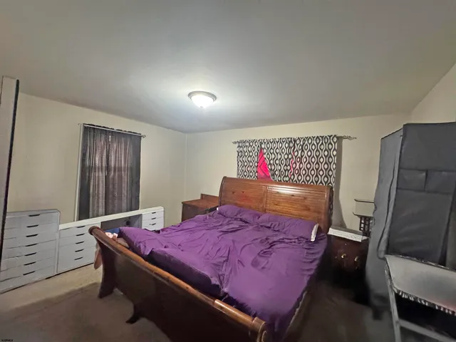 a bed room with a bed and a tv