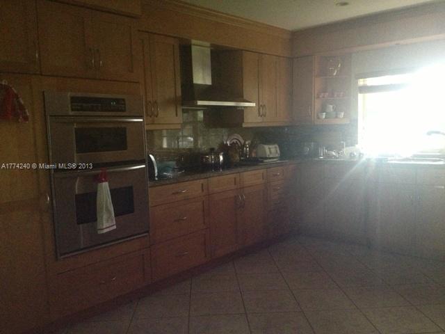 4825 Granada Boulevard Coral Gables, FL 33146 - Photo 3 of 8 a kitchen with appliances and cabinets