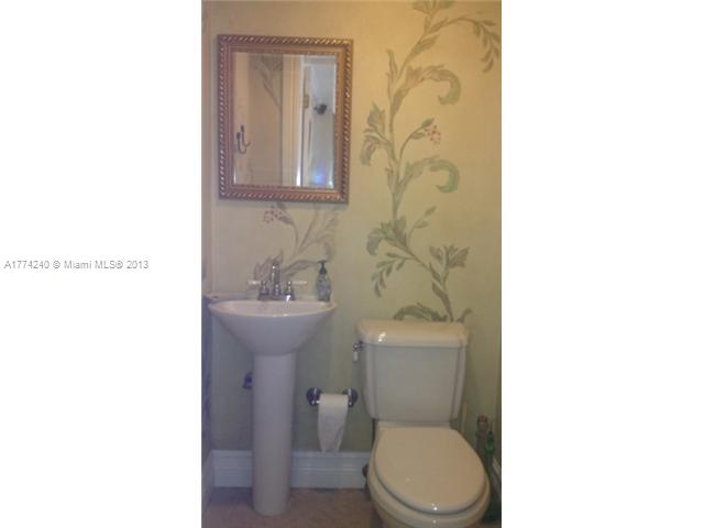 4825 Granada Boulevard Coral Gables, FL 33146 - Photo 5 of 8 a white toilet sitting next to a white sink